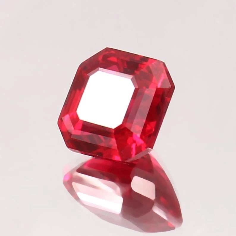 Red ruby Mogok gemstone on a light gray background