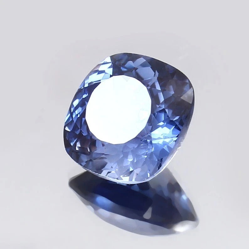 Blue Sapphire gemstone on a light gray background