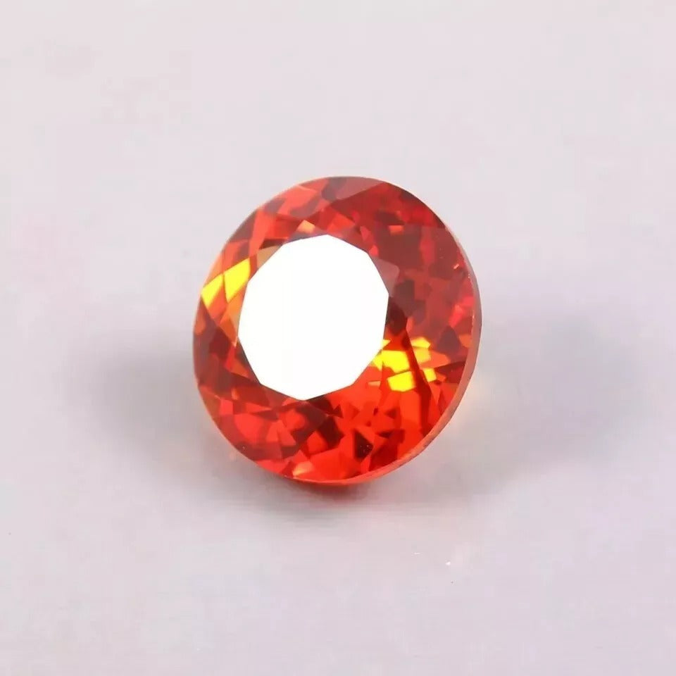 Orange Sapphire gemstone on a light gray background