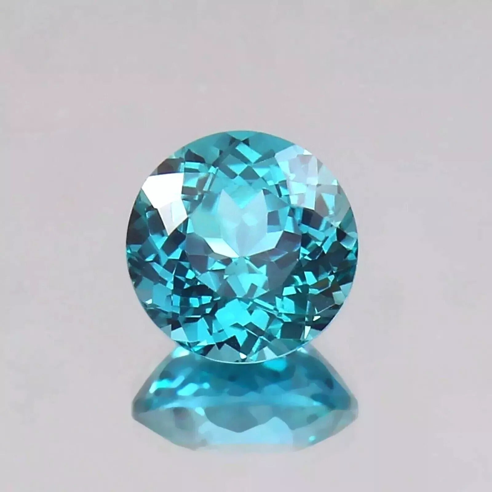 Faceted Parti Sapphire gemstone on a light gray background