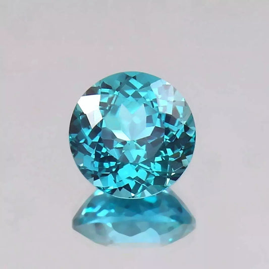Faceted Parti Sapphire gemstone on a light gray background
