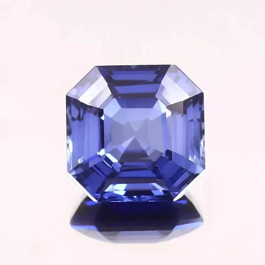 Faceted Royal Blue Sapphire gemstone on a white background