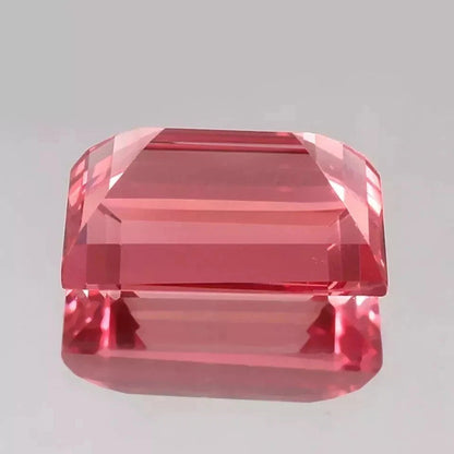 Padparadscha Sapphire – Baguette Cut gemstone on a gray background