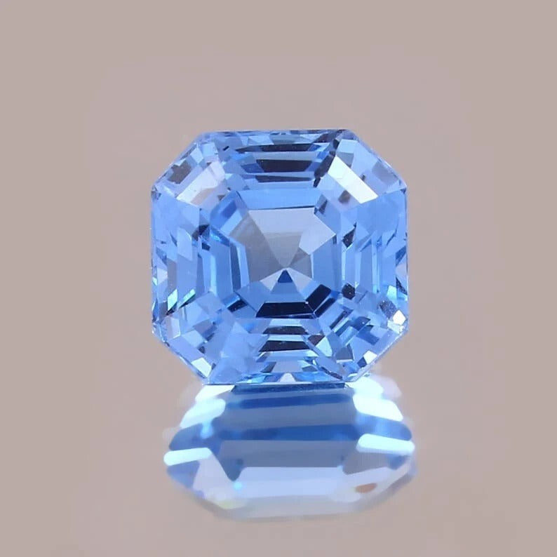 Blue Spinel gemstone with a clear brown background
