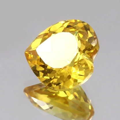 Yellow Sapphire gemstone on a gray background