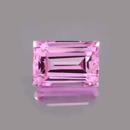 Pink Baguette Cut sapphire gemstone on a gray background