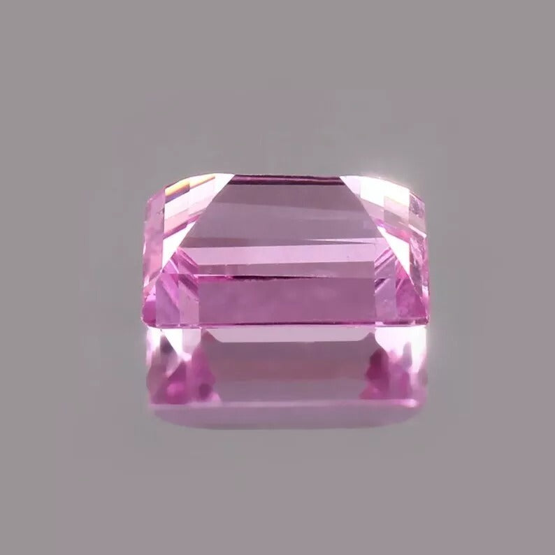 Pink Baguette Cut sapphire gemstone on a gray background