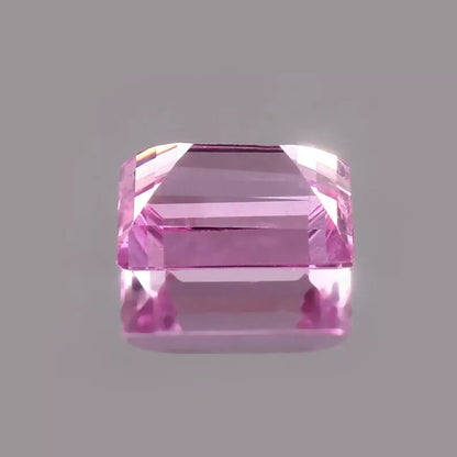 Pink Baguette Cut sapphire gemstone on a gray background