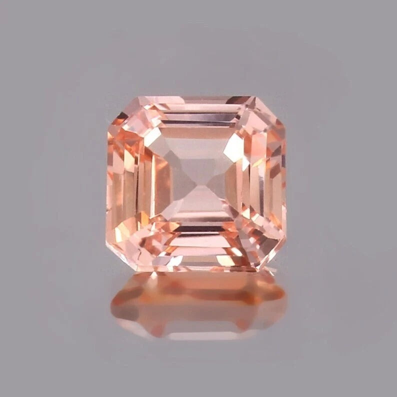 Padparadscha Sapphire – Peach gemstone on a gray background