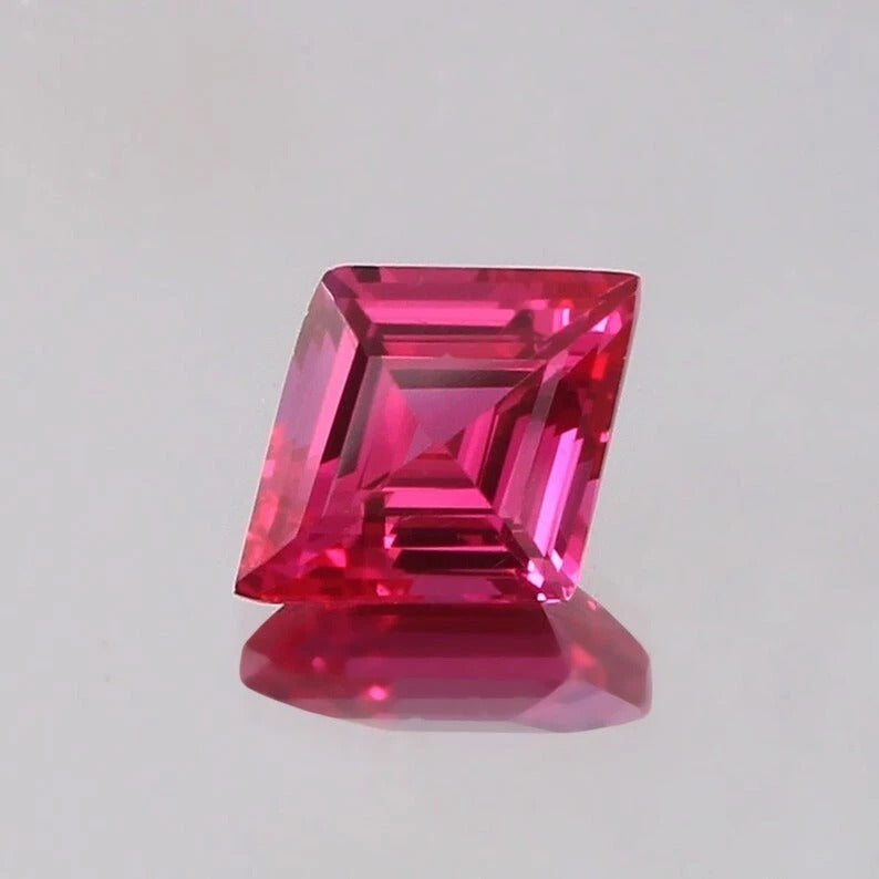 Lozenge Pink Sapphire gemstone on a light gray background