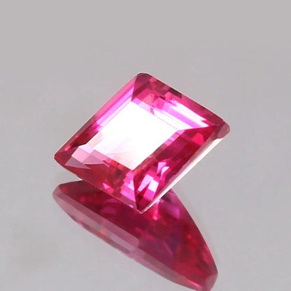 Lozenge Pink Sapphire 
gemstone on a gray background