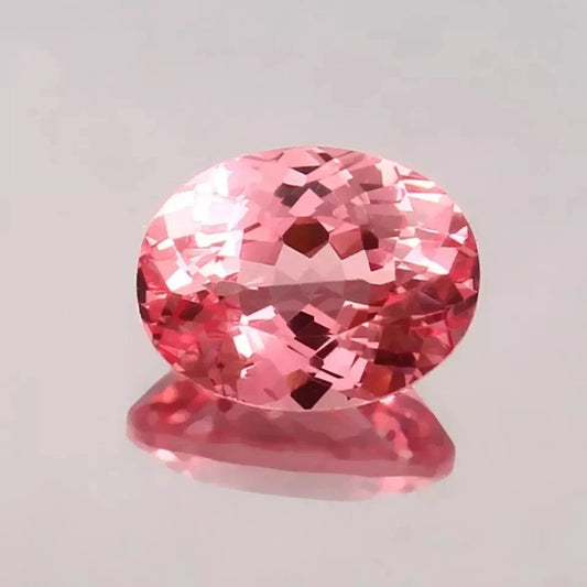 Padparadscha Sapphire Peach To Pink gemstone on a light gray background