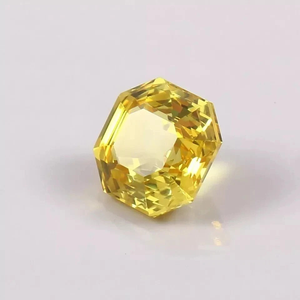 Yellow Sapphire asscher on a light gray background