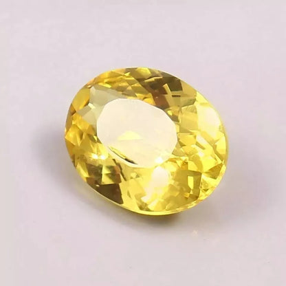 Yellow Sapphire gemstone on a light pink background
