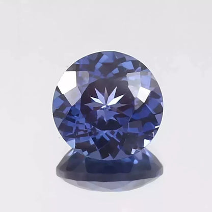 Royal Blue Sapphire Round Cut gemstone on a light gray background