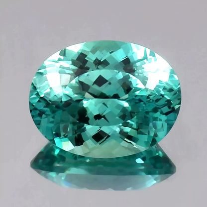 Faceted Bi-Color Parti-Sapphire gemstone on a gray background
