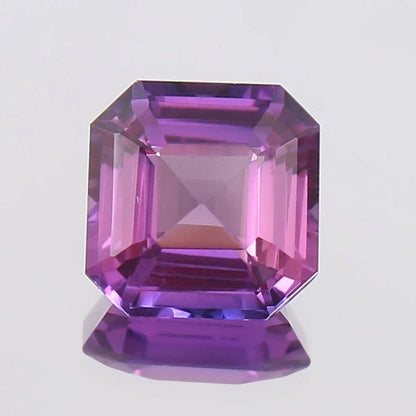 Purple Pink Sapphire gemstone with a clear background