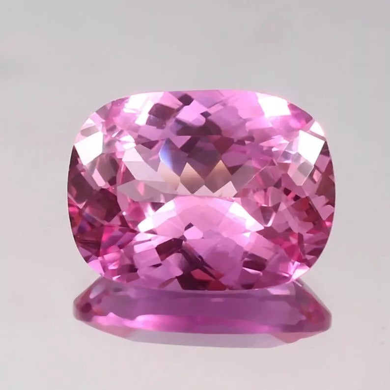 Unheated Pink Sapphire gemstone on a light gray background