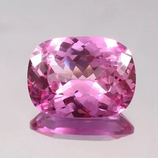 Unheated Pink Sapphire gemstone on a light gray background