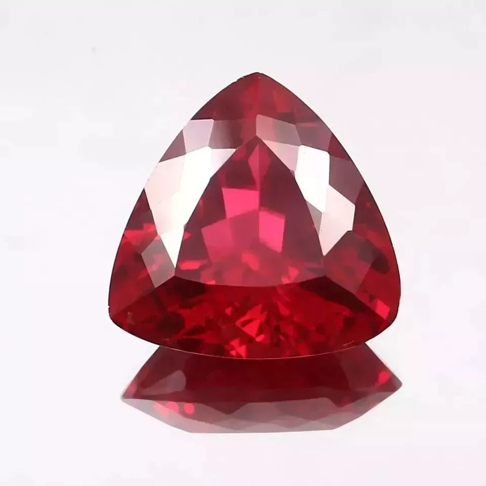 Mozambique Blood Red Ruby Trillion Cut gemstone on a white background