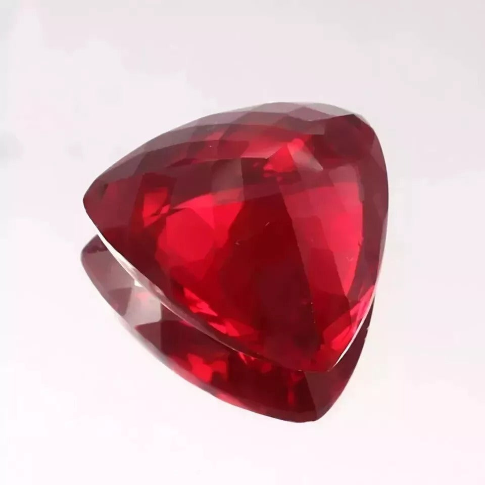 Mozambique Blood Red Ruby Trillion Cut gemstone on a white background