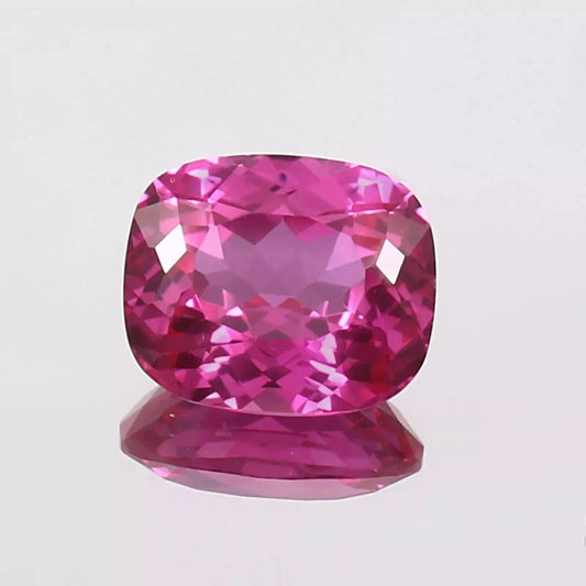 Pink sapphire gemstone on a light gray background