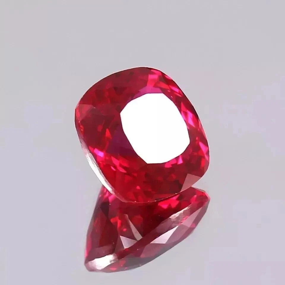 Red Mozambique Ruby gemstone on a light gray background