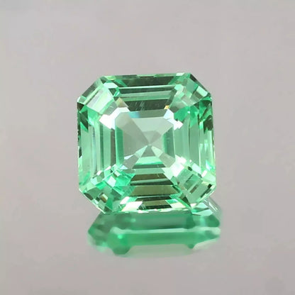sapphire asscher cut green gemstone on a gray background