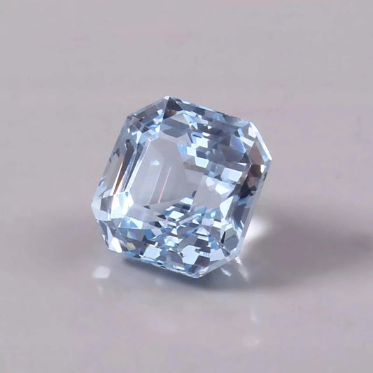 Faceted Sky Blue Color Aquamarine gemstone on a light gray background