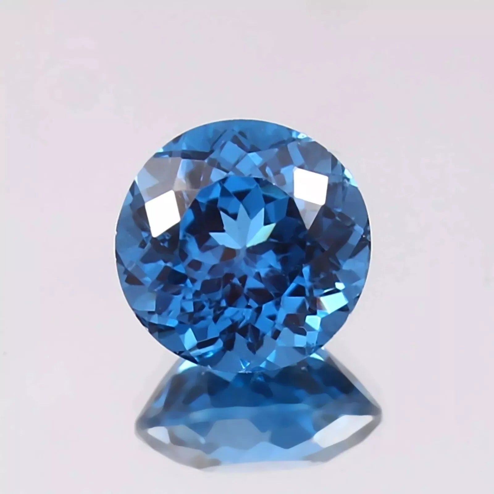 Indicolite Blue Color Tourmaline gemstone on a light gray background