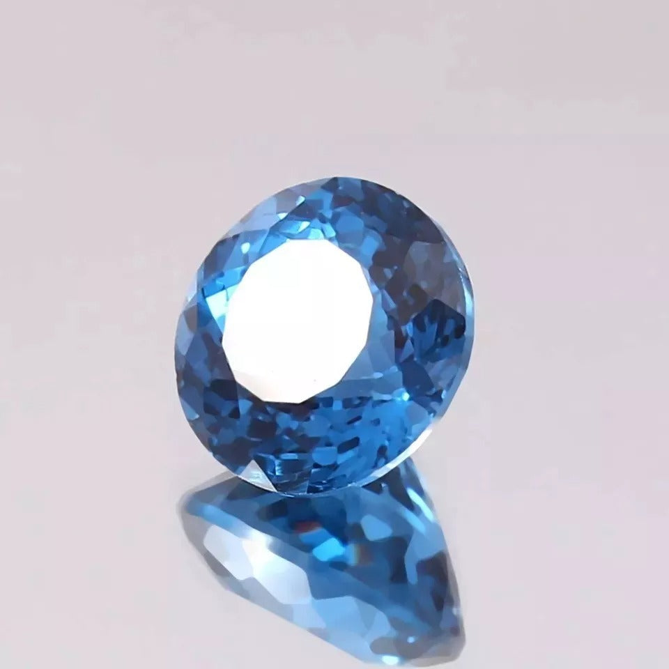 Faceted Indicolite Blue Color Tourmaline  gemstone on a light gray background