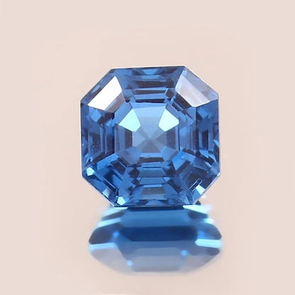 Indicolite Tourmaline blue gemstone with a beige background