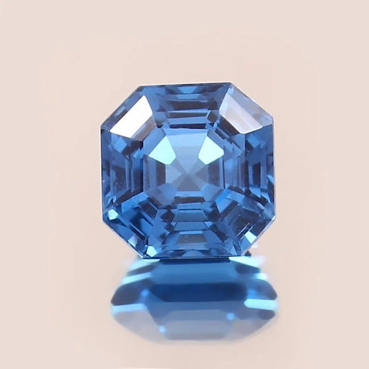 Indicolite Tourmaline blue gemstone with a beige background