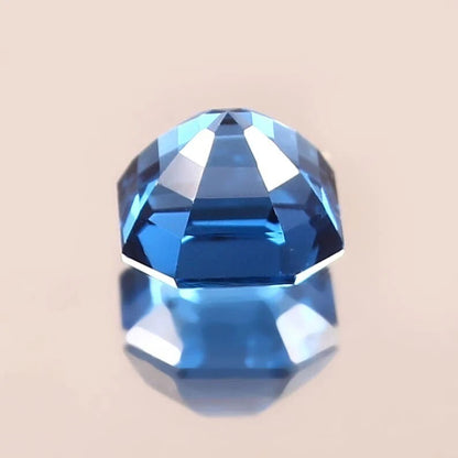 Faceted blue  Indicolite Tourmaline gemstone on a beige background
