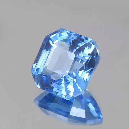 Ceylon Blue Sapphire gemstone on a gray background