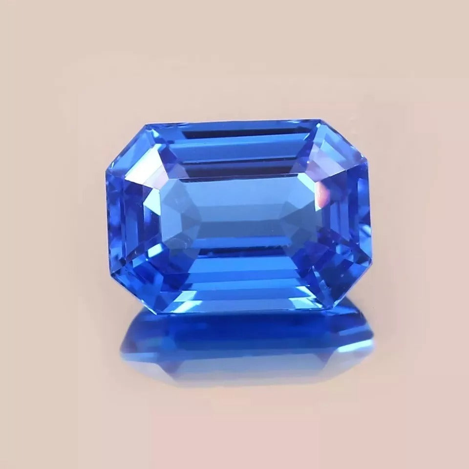 Faceted Blue sapphire sri lanka gemstone on a beige background