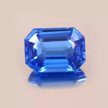 Faceted Blue sapphire sri lanka gemstone on a beige background
