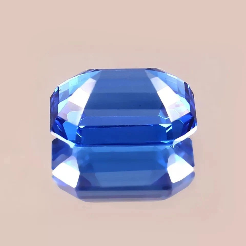 Faceted Blue sapphire sri lanka gemstone on a beige background