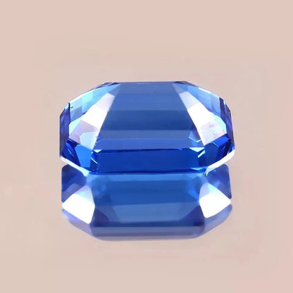 Faceted Blue sapphire sri lanka gemstone on a beige background
