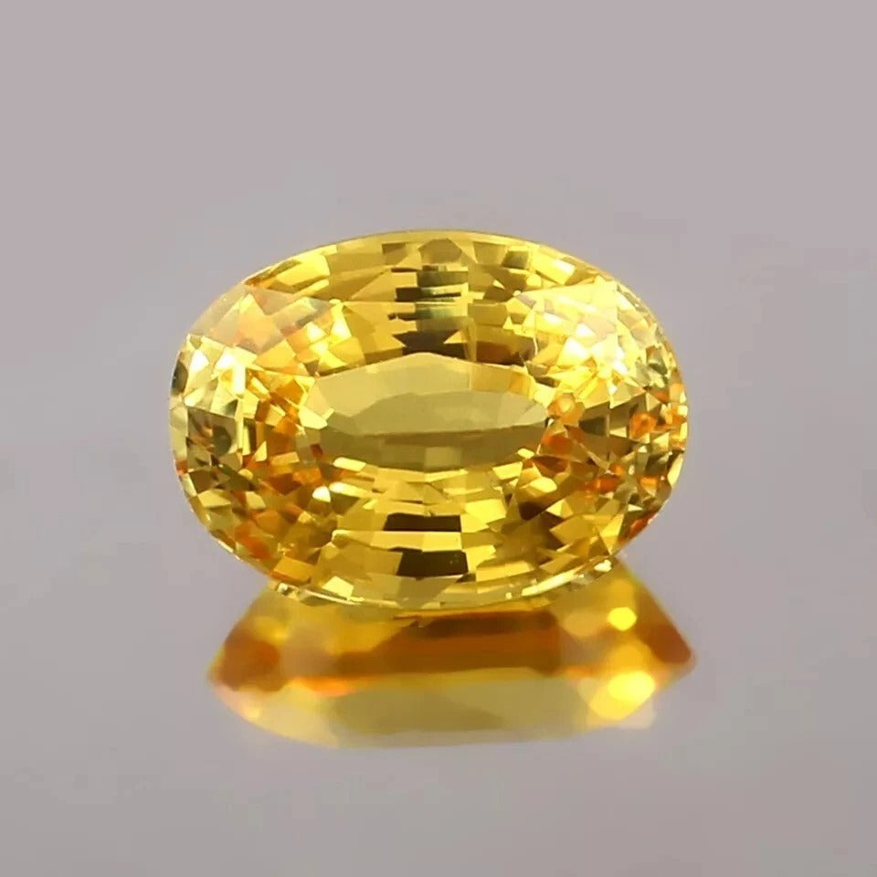 Yellow Sapphire gemstone on a gray background