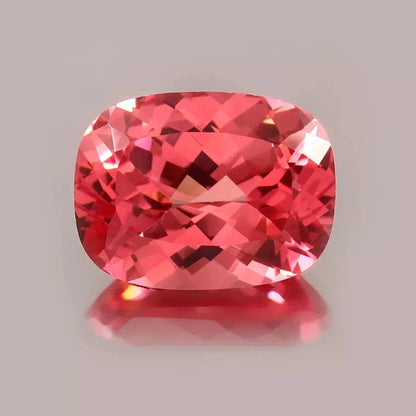 Cushion-shaped Padparadscha Sapphire gemstone on a gray background